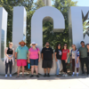 Scholars in front of UCR Sign